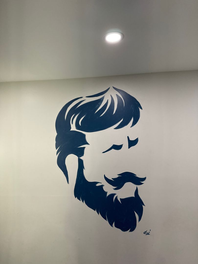 The shop wall mural - the barber-face logo painted large